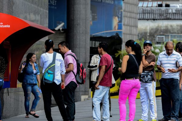Venezolanos cazan a diario dinero en efectivo cada vez más escaso